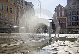 Woman playing with a fountain photo