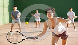 Woman playing frontenis on outdoor pelota court photo