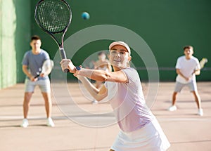 Woman playing frontenis on outdoor pelota court photo