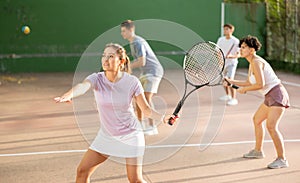 Woman playing frontenis on outdoor pelota court photo