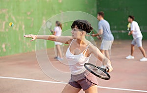 Woman playing frontenis on outdoor pelota court photo