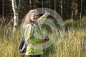 Woman playing geocaching.