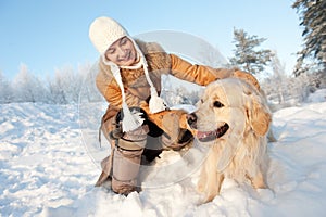 Woman playing with golden retriever outdoors