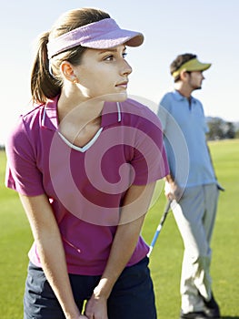 Woman Playing Golf With Male Friend