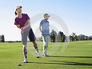 Woman Playing Golf With Male Friend