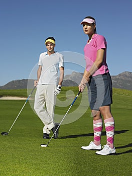 Woman Playing Golf With Male Friend