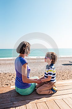 Woman playing with her son on the beach