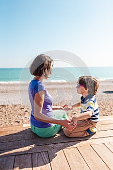 Woman playing with her son on the beach