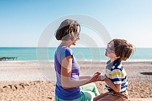 Woman playing with her son on the beach