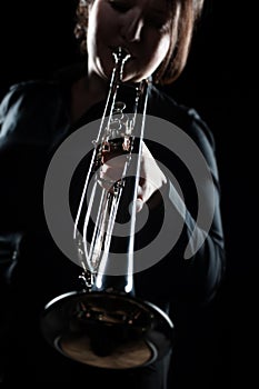 Woman playing jazz trumpet brass band