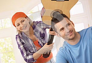 Woman playing joke of guitar attack photo