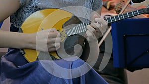 Woman playing mandolin