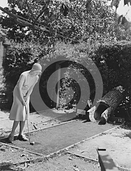 Woman playing miniature golf