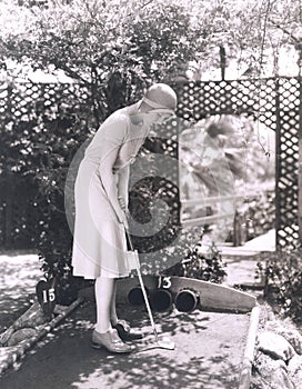 Woman playing miniature golf