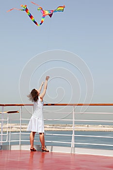 Woman playing with multicolored kite