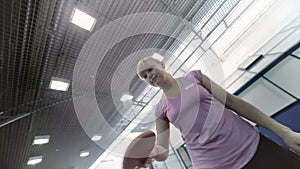 The woman playing the ping-pong at the court, the camera incline