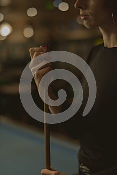 Woman playing pool at a bar