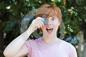 Woman playing with a popular fidget spinner toy, anxiety relief toy, anti stress and relaxation fidgets