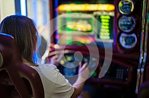 Woman playing racing simulator game