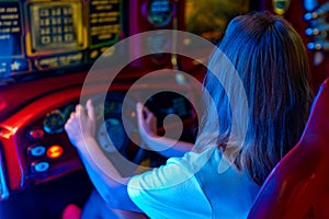 Woman playing racing simulator game