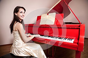 Woman playing the red grand piano