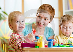 Woman playing and teaching with children