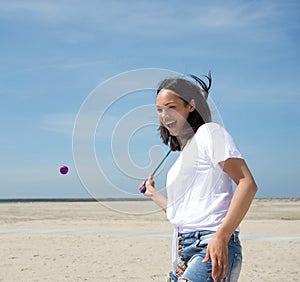 Woman playing tennis at the beach