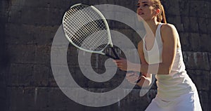 Woman playing tennis on a sunny day