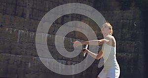 Woman playing tennis on a sunny day