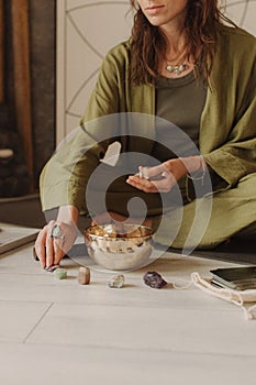 Woman playing on Tibetan singing bowl while sitting. Vintage tonned. Soft focus blurred and noise effect