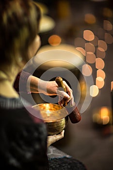 Woman playing on a tibetian singing bowl