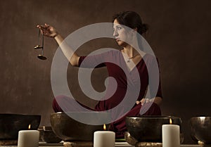 Woman playing tingsha (Tibetan bells)