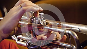 Woman playing trumpet. Trumpet player. Trumpeter playing music jazz instrument. Brass orchestra instrument. Woman plays