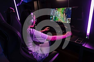 Woman playing video game in cybersport club