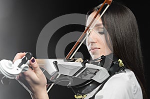 Woman playing the violin on a black background