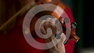 Woman playing the violin. Hands of musician, close up view