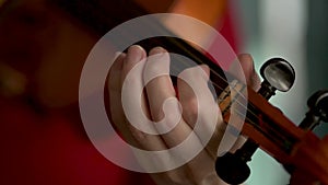 Woman playing the violin. Hands of musician, close up view