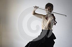 Woman playing violin with happy feeling,smiling face,practice acoustic instrument