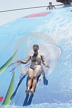 Woman playing on wet bubble game pool