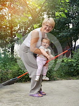 Woman is playing witches with her litle granddaugh