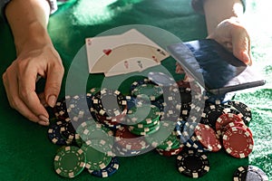 A woman plays in a casino. opening cards to raise bets. Against the background of chips. Poker victory