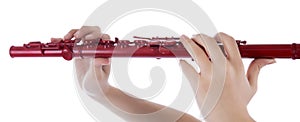 Woman plays the flute against white background