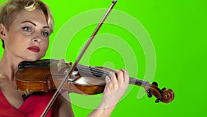 Woman plays the violin. Green screen. Close up