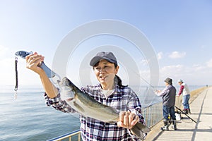 A woman pleased to catch a big fish