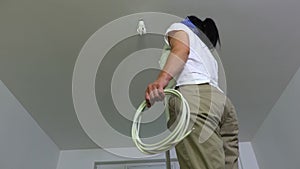 Woman with pliers and electrically conductive wires on a metal stairs