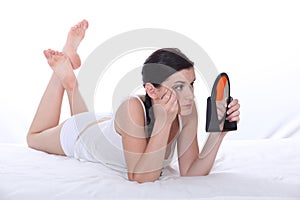 Woman plucking eyebrows