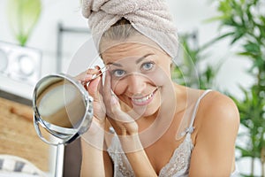 woman plucking eyebrows depilating