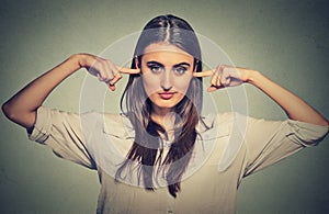 Woman plugging ears doesn't want to listen photo