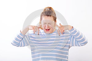 Woman plugging ears, pretending not to hear what she is told