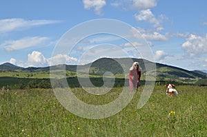 Woman Plying with Her Dog in Landscape photo
